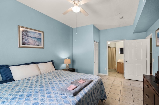 tiled bedroom featuring a closet, ceiling fan, and ensuite bath