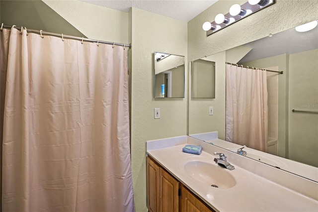 bathroom with a textured ceiling and vanity