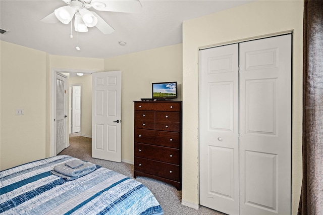 bedroom with light colored carpet, a closet, and ceiling fan