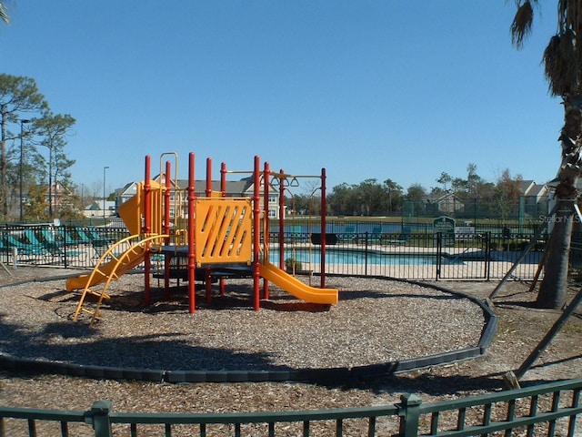 view of jungle gym with a community pool