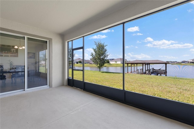 unfurnished sunroom with a water view and a notable chandelier