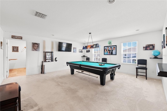 recreation room featuring light carpet, pool table, and a textured ceiling