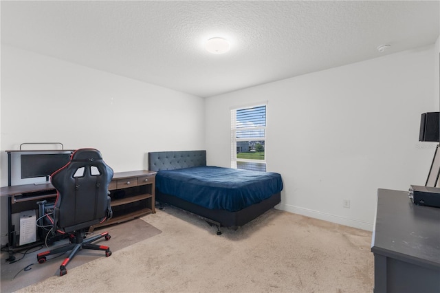 bedroom featuring light colored carpet and a textured ceiling