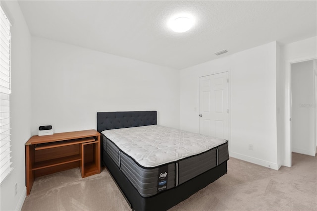 bedroom featuring light colored carpet