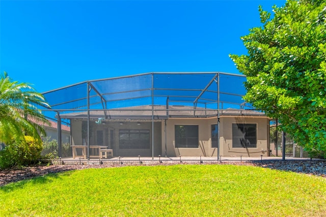 rear view of property featuring a yard