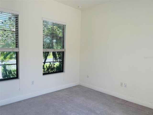 carpeted spare room featuring a healthy amount of sunlight