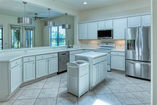 kitchen with a kitchen island, stainless steel appliances, pendant lighting, sink, and light tile floors