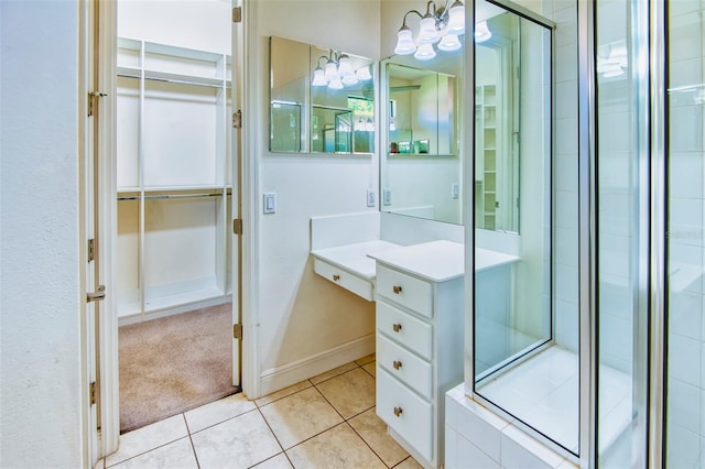 bathroom featuring tile floors, an enclosed shower, and vanity