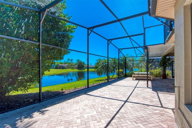 unfurnished sunroom featuring a water view