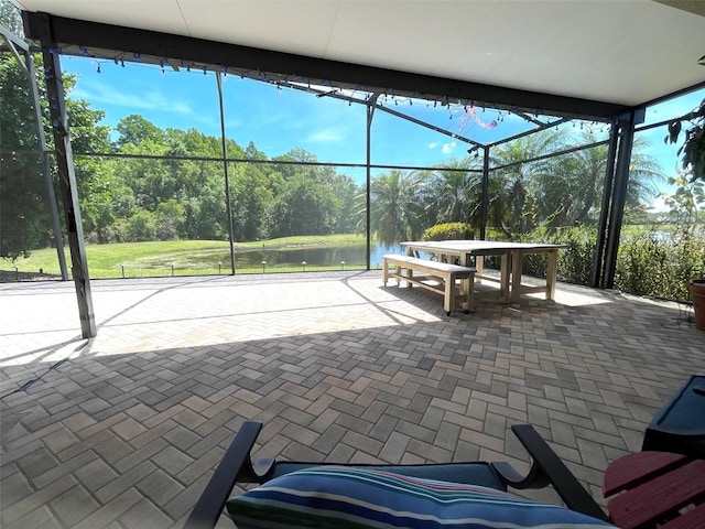 sunroom / solarium featuring a water view