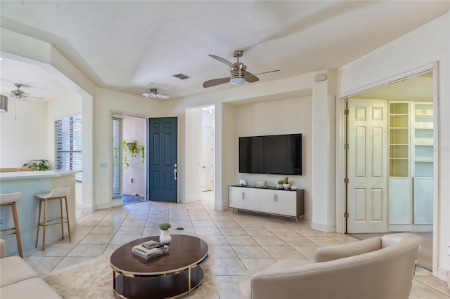 tiled living room featuring ceiling fan