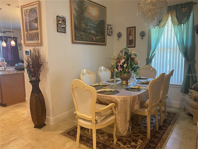 2410 Datura Loop, Saint Cloud, FL 34772 - dining room featuring light tile patterned flooring, baseboards, and a chandelier