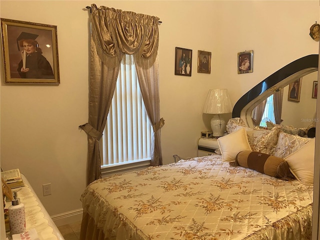 2410 Datura Loop, Saint Cloud, FL 34772 - bedroom featuring arched walkways, baseboards, and tile patterned floors