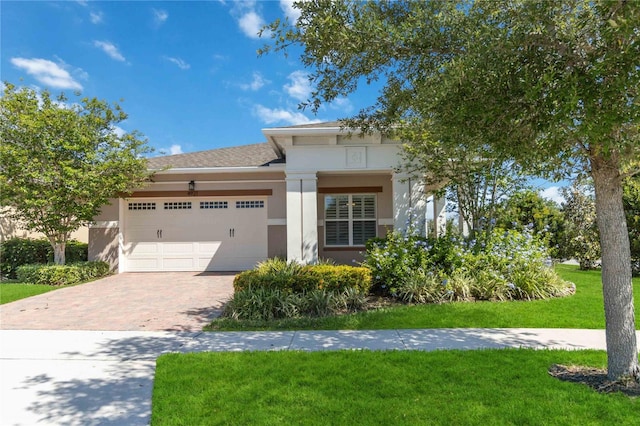 view of front of home with a front lawn and a garage