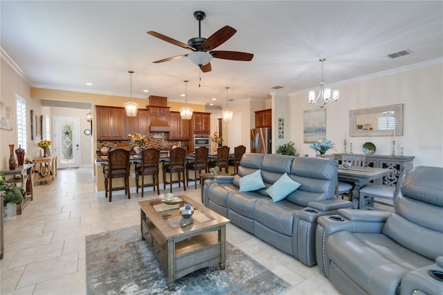 tiled living room featuring ceiling fan with notable chandelier and crown molding