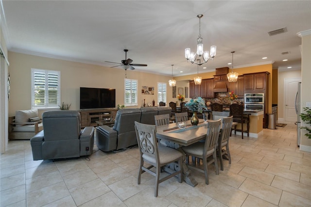 tiled dining area with a wealth of natural light, ornamental molding, and ceiling fan with notable chandelier