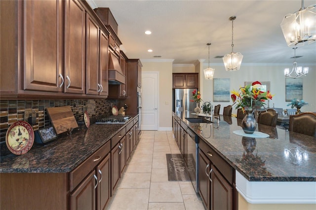 kitchen featuring decorative light fixtures, backsplash, appliances with stainless steel finishes, sink, and an inviting chandelier