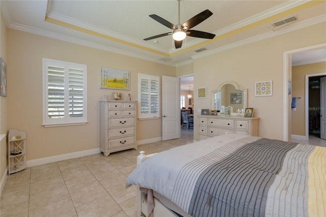 tiled bedroom featuring crown molding, ceiling fan, and a raised ceiling