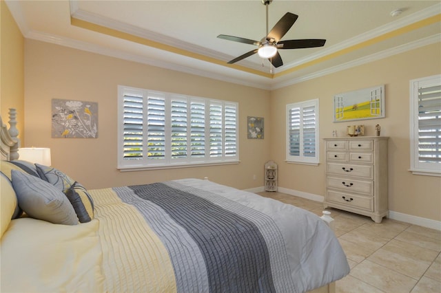 tiled bedroom featuring multiple windows, ceiling fan, a raised ceiling, and crown molding