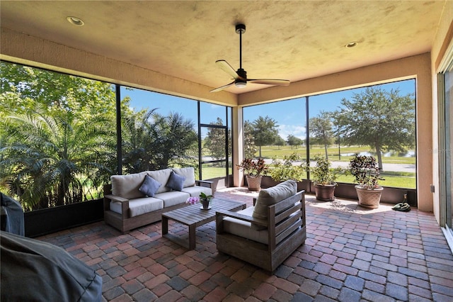 sunroom / solarium featuring ceiling fan