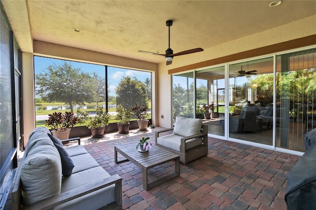 sunroom / solarium featuring ceiling fan