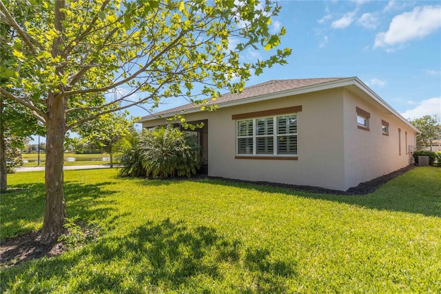 view of side of home featuring a yard