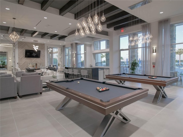 recreation room with indoor bar, light tile floors, billiards, and an inviting chandelier