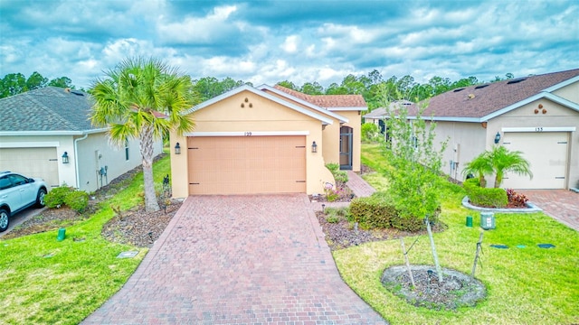 ranch-style home with a front lawn and a garage