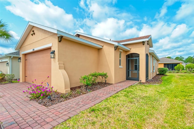 view of front of property with a garage and a front lawn