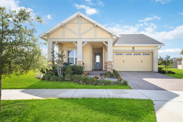 craftsman-style home with a front yard, a garage, and covered porch