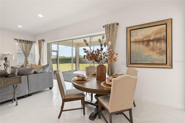 dining room with light tile floors and a wealth of natural light