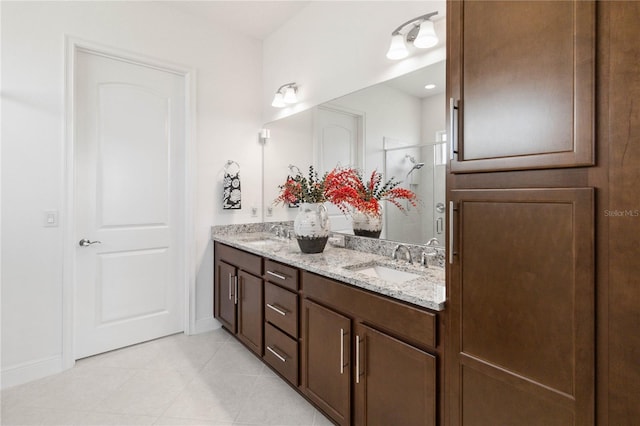 bathroom with dual bowl vanity and tile flooring