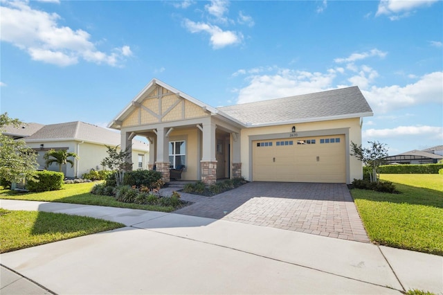 craftsman house with a garage, a front lawn, and covered porch