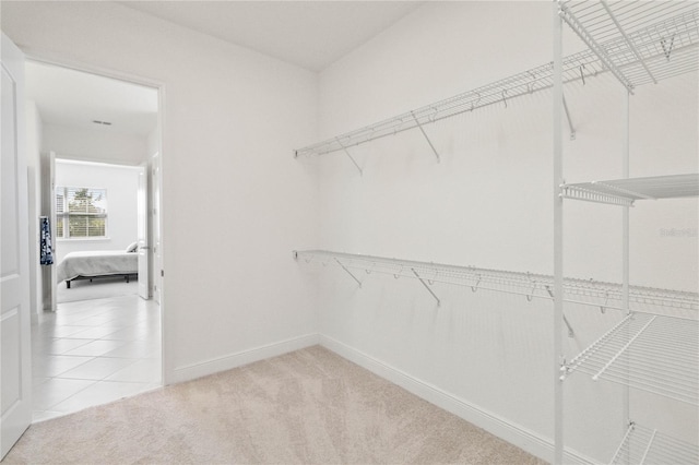 walk in closet featuring light tile floors