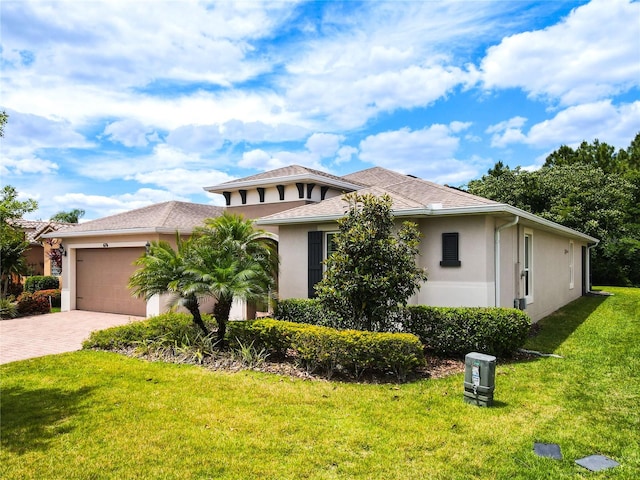 view of front of house with a garage and a front yard