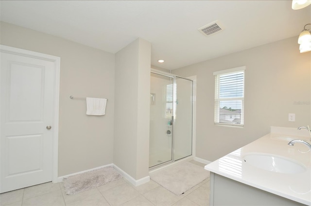 bathroom with tile patterned floors, vanity, and an enclosed shower