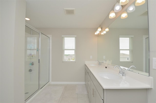 bathroom featuring tile patterned floors, vanity, and an enclosed shower