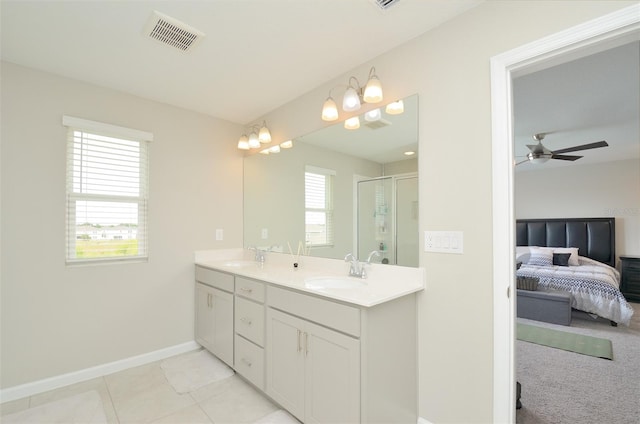 bathroom featuring vanity, a shower with door, tile patterned floors, and ceiling fan