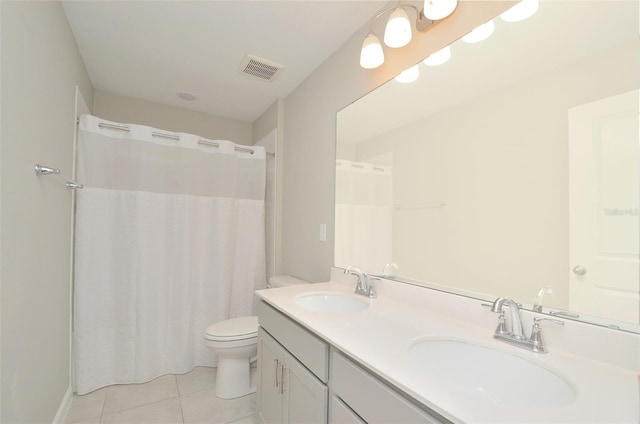 bathroom with tile patterned flooring, vanity, toilet, and curtained shower