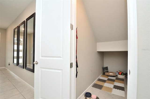 hall featuring light tile patterned floors