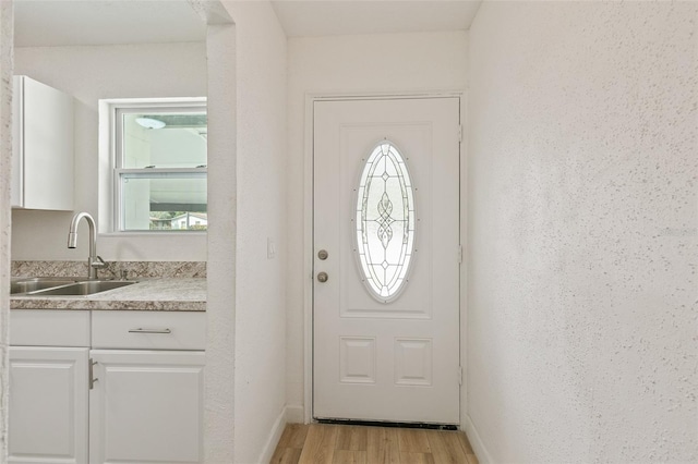 entryway featuring light hardwood / wood-style flooring and sink