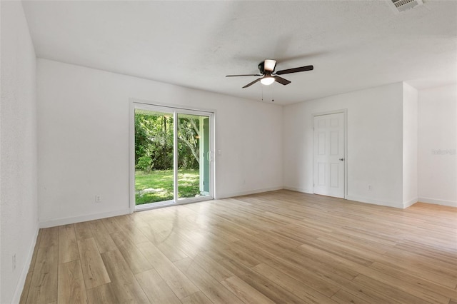 spare room with ceiling fan and light wood-type flooring