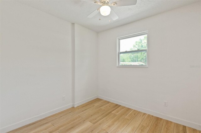 empty room featuring a textured ceiling, ceiling fan, and light wood-type flooring