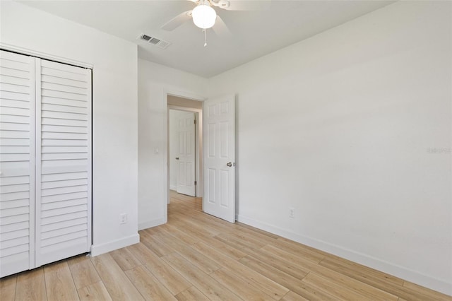 unfurnished bedroom featuring a closet, light hardwood / wood-style floors, and ceiling fan