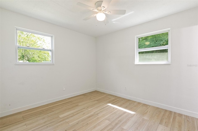 spare room featuring light hardwood / wood-style floors, plenty of natural light, and ceiling fan