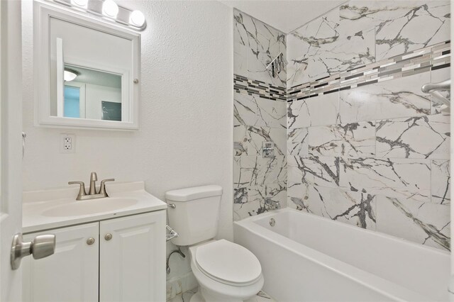 full bathroom with vanity with extensive cabinet space, tiled shower / bath, and toilet