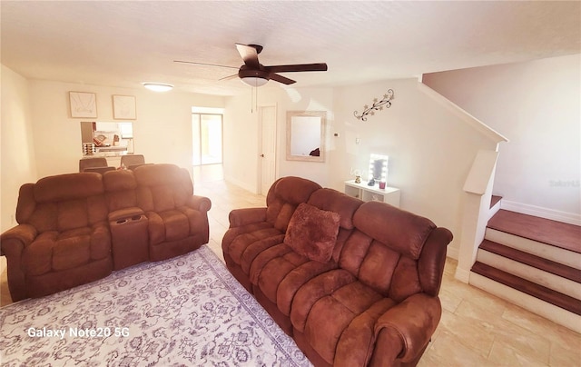 tiled living room with ceiling fan