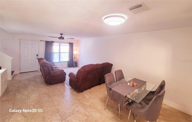 dining area with ceiling fan and light tile floors