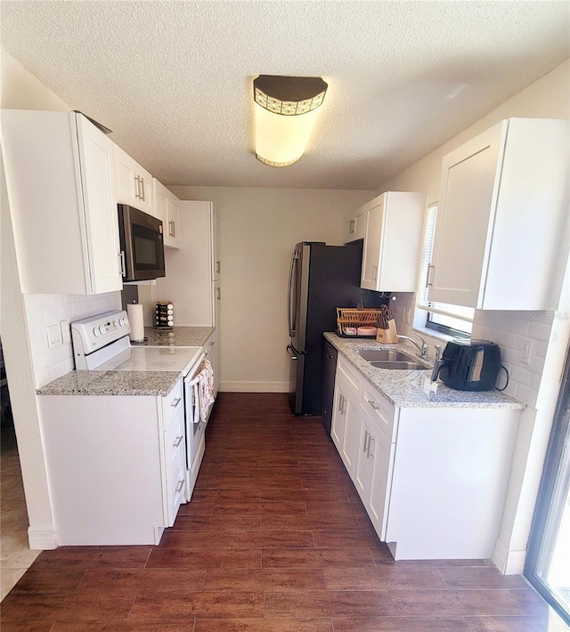 kitchen with sink, white cabinetry, black appliances, and dark wood-type flooring