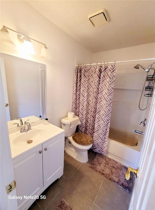 full bathroom featuring shower / tub combo, toilet, tile flooring, a textured ceiling, and vanity